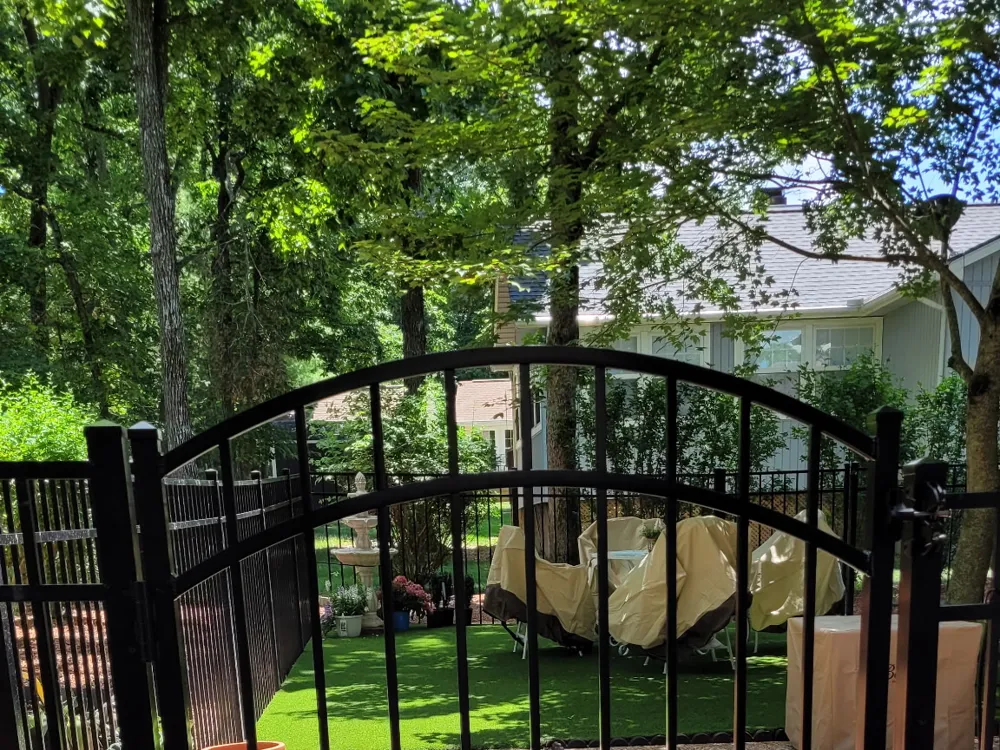Black aluminum fence panels with arched walk gate by RB Fence